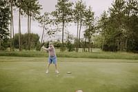 man hitting a golf ball with a golf club